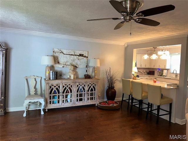 301 W Clipper St, Kennett, MO 63857 - dining area featuring ornamental molding, dark wood-style floors, ceiling fan, and a textured ceiling