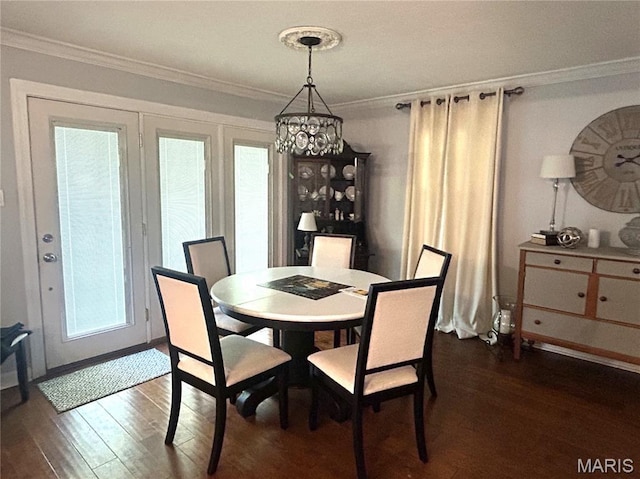 301 W Clipper St, Kennett, MO 63857 - dining space with dark wood-style flooring, crown molding, a chandelier, and plenty of natural light