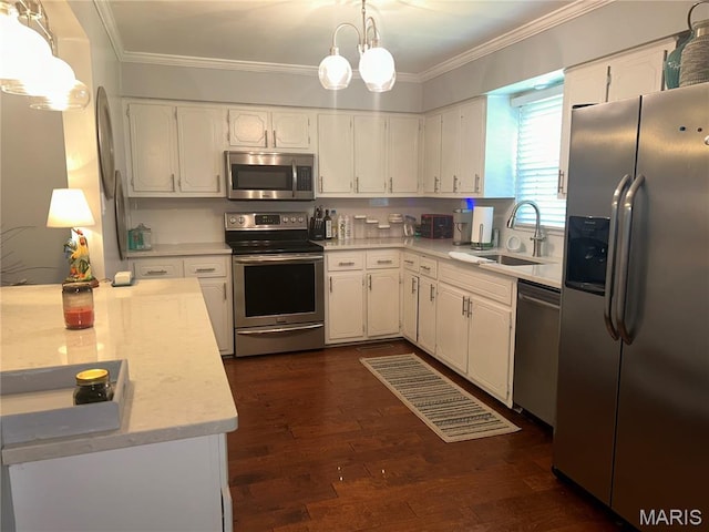 301 W Clipper St, Kennett, MO 63857 - kitchen featuring stainless steel appliances, light countertops, ornamental molding, white cabinets, and a chandelier