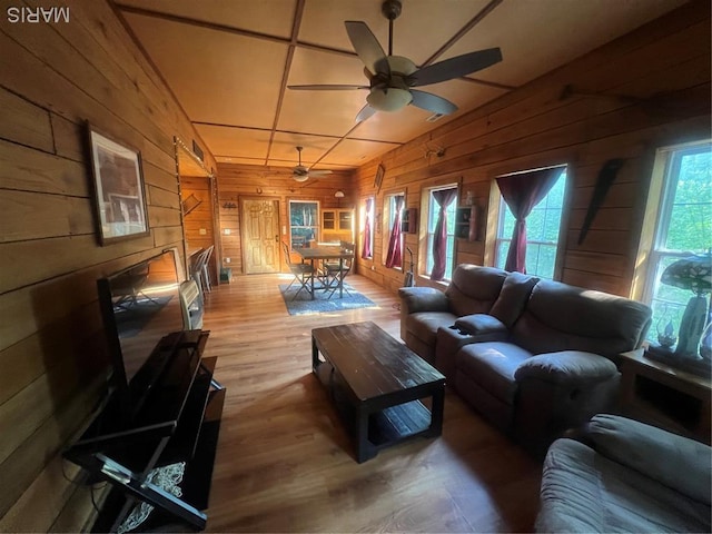 171 Bluffview Cir, Piedmont, MO 63957 - living room featuring wooden walls, a ceiling fan, and wood finished floors