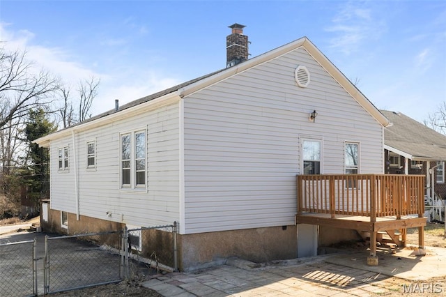 1307 Weleba Ave, Saint Louis, MO 63121 - back of house featuring a deck, a chimney, a gate, and a patio area