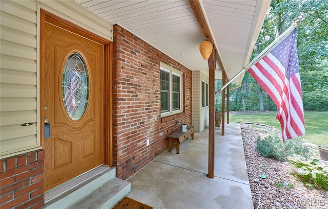 271 Westwood Trl, Foristell, MO 63348 - doorway to property with covered porch and brick siding
