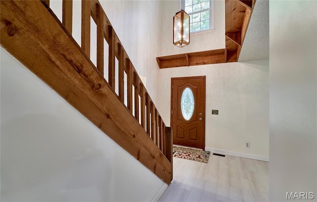 271 Westwood Trl, Foristell, MO 63348 - entrance foyer with healthy amount of natural light, a high ceiling, stairway, and wood finished floors