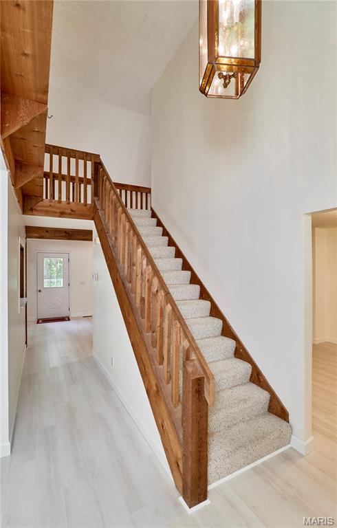 271 Westwood Trl, Foristell, MO 63348 - staircase with wood finished floors and baseboards