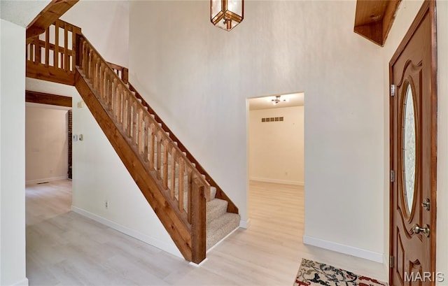 271 Westwood Trl, Foristell, MO 63348 - staircase featuring wood finished floors and a towering ceiling