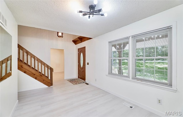 271 Westwood Trl, Foristell, MO 63348 - entrance foyer with wood finished floors, a textured ceiling, stairs, and a chandelier