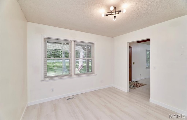 271 Westwood Trl, Foristell, MO 63348 - empty room with light wood-style flooring and a textured ceiling