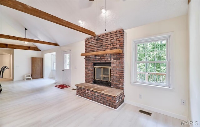 271 Westwood Trl, Foristell, MO 63348 - unfurnished living room featuring a fireplace, plenty of natural light, and wood finished floors