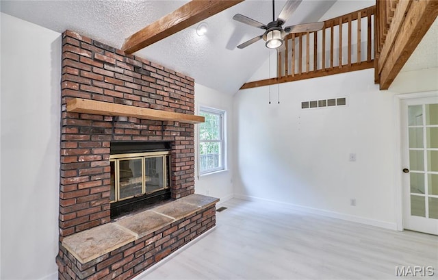 271 Westwood Trl, Foristell, MO 63348 - unfurnished living room with wood finished floors, a brick fireplace, a ceiling fan, and a textured ceiling
