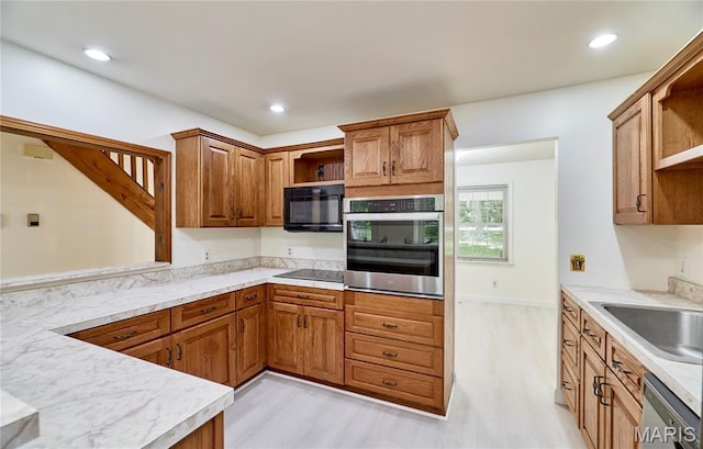 271 Westwood Trl, Foristell, MO 63348 - kitchen with black appliances, open shelves, light wood-style floors, light countertops, and recessed lighting