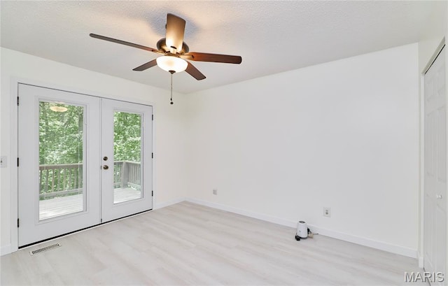 271 Westwood Trl, Foristell, MO 63348 - spare room with light wood-type flooring, french doors, ceiling fan, and a textured ceiling