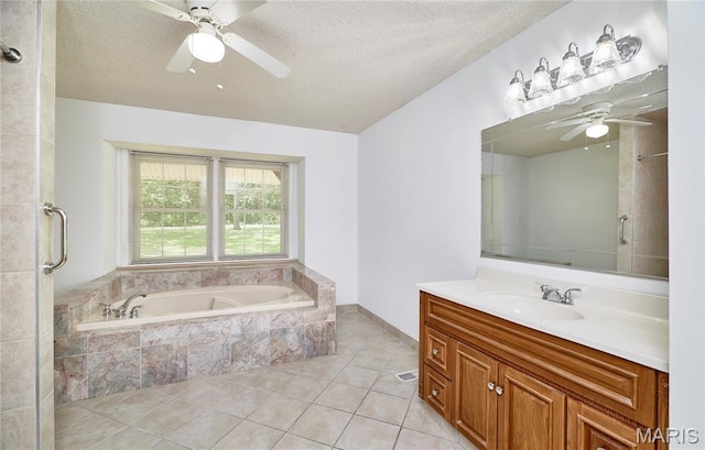 271 Westwood Trl, Foristell, MO 63348 - full bath featuring a ceiling fan, vanity, a textured ceiling, a bath, and tile patterned floors