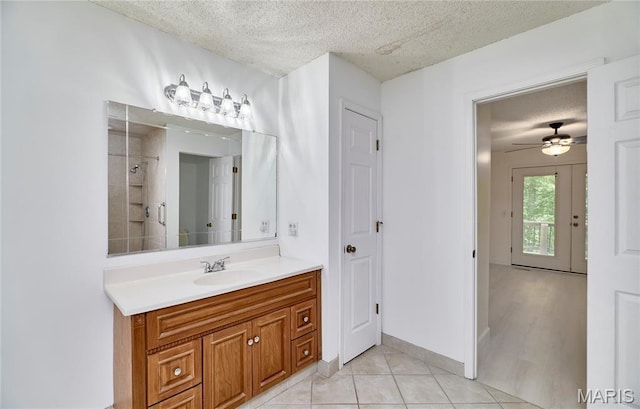 271 Westwood Trl, Foristell, MO 63348 - bathroom featuring a textured ceiling, vanity, tile patterned floors, a shower, and a ceiling fan