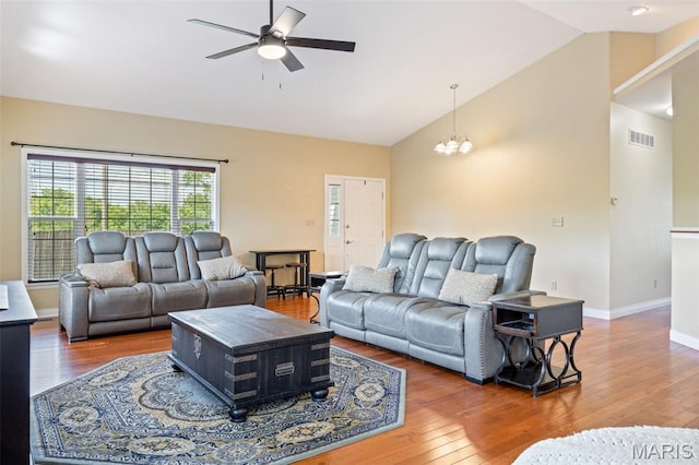7156 Mardel Ave, Saint Louis, MO 63109 - living area with ceiling fan, wood finished floors, a chandelier, and high vaulted ceiling