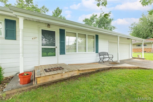 457 Maple Dr, Bethalto, IL 62010 - back of house featuring a yard, a garage, concrete driveway, and a wooden deck