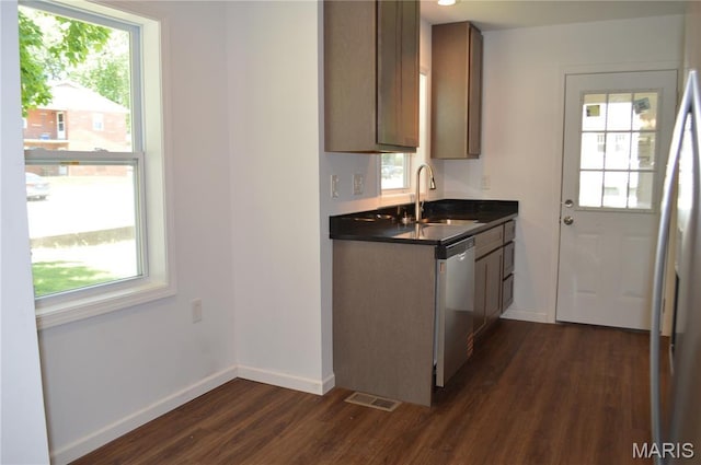 834 Vine St, Festus, MO 63028 - kitchen featuring stainless steel dishwasher, dark wood finished floors, dark countertops, and fridge