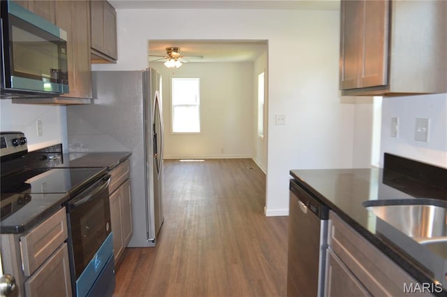 834 Vine St, Festus, MO 63028 - kitchen with stainless steel appliances, dark wood-style floors, ceiling fan, and dark stone counters