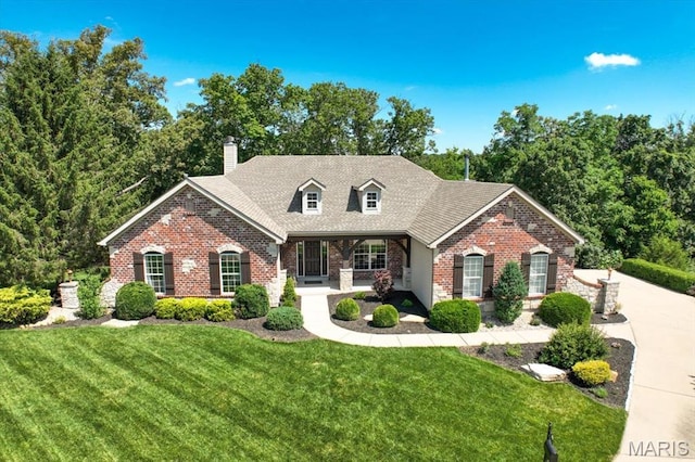 886 Arbor Chase Dr, Wildwood, MO 63021 - view of front of property with brick siding, a front lawn, a chimney, a porch, and roof with shingles