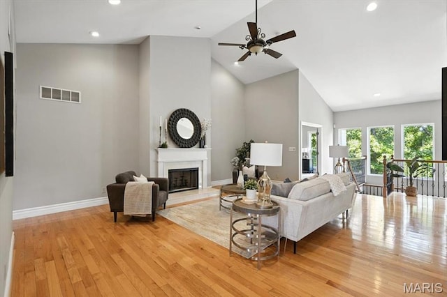 886 Arbor Chase Dr, Wildwood, MO 63021 - living area featuring a ceiling fan, light wood-style flooring, a glass covered fireplace, high vaulted ceiling, and recessed lighting