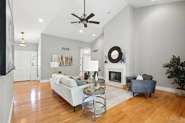 886 Arbor Chase Dr, Wildwood, MO 63021 - living area with a ceiling fan, high vaulted ceiling, a glass covered fireplace, light wood-type flooring, and recessed lighting