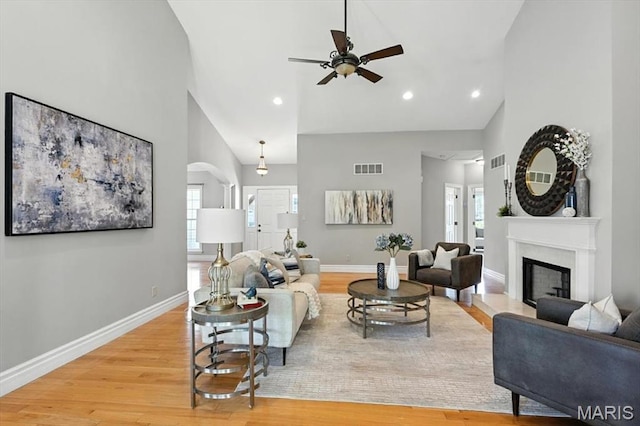 886 Arbor Chase Dr, Wildwood, MO 63021 - living area featuring ceiling fan, high vaulted ceiling, light wood-type flooring, a fireplace with raised hearth, and recessed lighting