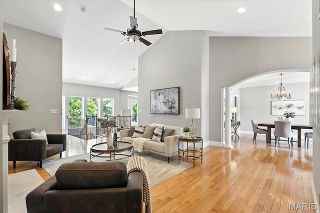 886 Arbor Chase Dr, Wildwood, MO 63021 - living room featuring arched walkways, light wood-type flooring, high vaulted ceiling, a ceiling fan, and decorative columns