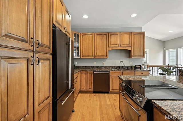886 Arbor Chase Dr, Wildwood, MO 63021 - kitchen with stainless steel appliances, light wood-style flooring, brown cabinets, dark stone countertops, and recessed lighting