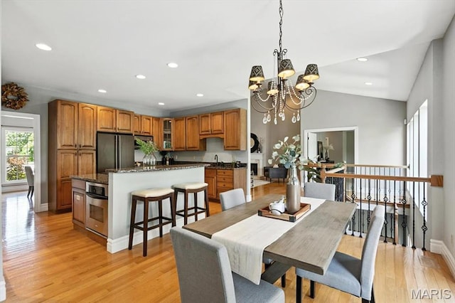 886 Arbor Chase Dr, Wildwood, MO 63021 - dining space featuring a chandelier, light wood-style floors, recessed lighting, and vaulted ceiling