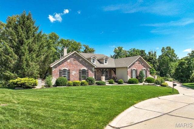 886 Arbor Chase Dr, Wildwood, MO 63021 - view of front of house with brick siding, a front yard, and a chimney