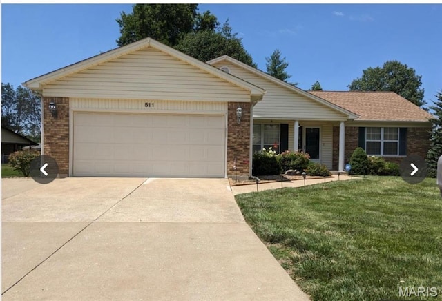 511 Pioneer Dr, Saint Charles, MO 63376 - ranch-style home featuring brick siding, a front lawn, driveway, and an attached garage