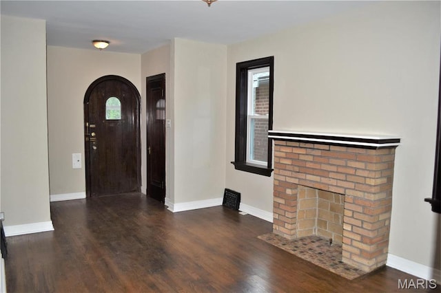 4521 Tholozan Ave, Saint Louis, MO 63116 - foyer featuring arched walkways, wood finished floors, and a fireplace
