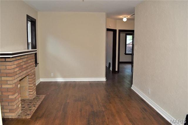 4521 Tholozan Ave, Saint Louis, MO 63116 - unfurnished living room with wood finished floors and a fireplace