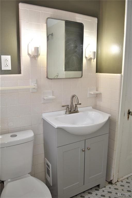 4521 Tholozan Ave, Saint Louis, MO 63116 - bathroom with tile walls, vanity, and tile patterned floors