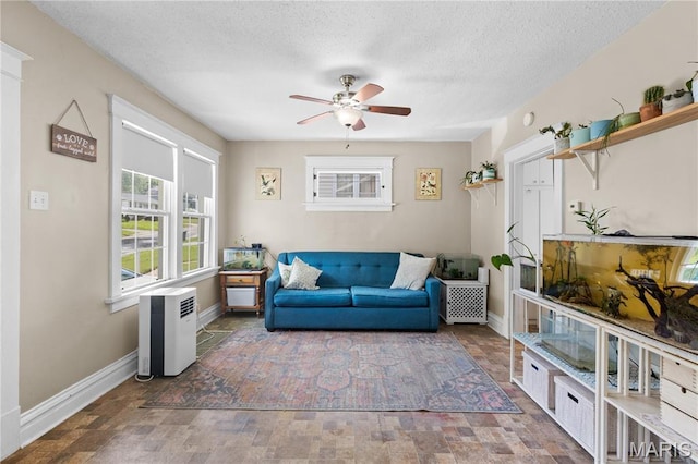 10225 Driver Ave, Overland, MO 63114 - living area with plenty of natural light, a ceiling fan, stone finish floors, and a textured ceiling