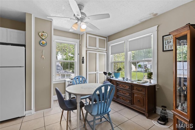 10225 Driver Ave, Overland, MO 63114 - dining area featuring ceiling fan, light tile patterned floors, and a textured ceiling