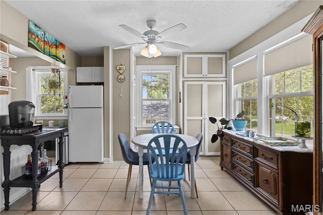 10225 Driver Ave, Overland, MO 63114 - dining area featuring ceiling fan, light tile patterned floors, and a textured ceiling