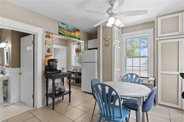 10225 Driver Ave, Overland, MO 63114 - dining space with a ceiling fan, light tile patterned floors, and a textured ceiling