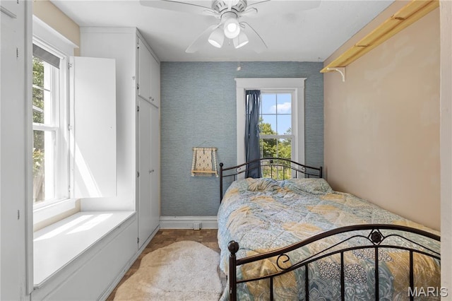 10225 Driver Ave, Overland, MO 63114 - bedroom with multiple windows, ceiling fan, and wallpapered walls
