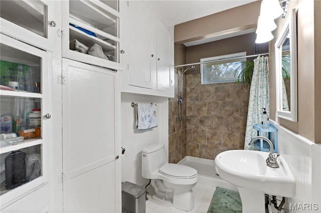 10225 Driver Ave, Overland, MO 63114 - full bath featuring tile patterned flooring, a tile shower, and a wainscoted wall