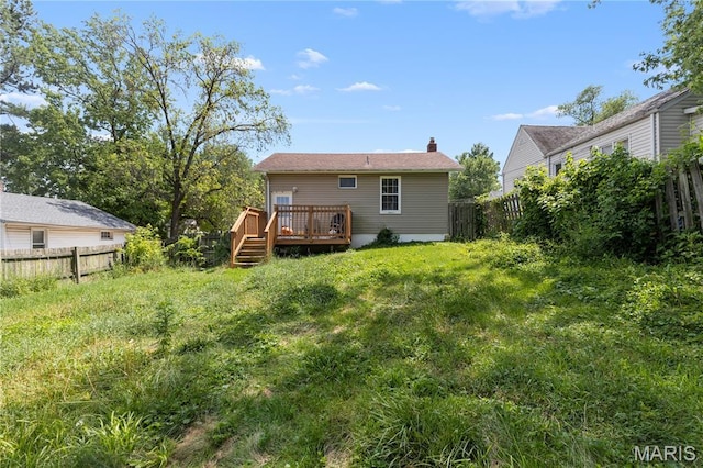 10225 Driver Ave, Overland, MO 63114 - back of property featuring a wooden deck, a fenced backyard, and a chimney