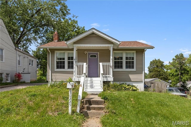 10225 Driver Ave, Overland, MO 63114 - bungalow featuring a chimney, roof with shingles, and covered porch