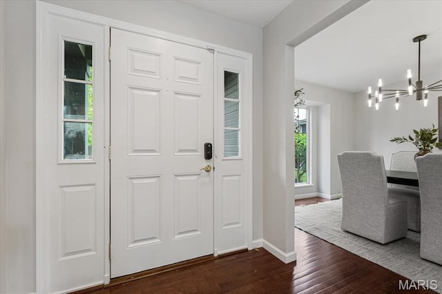 938 Blase Ave, Saint Louis, MO 63131 - foyer with a chandelier and dark wood-style floors