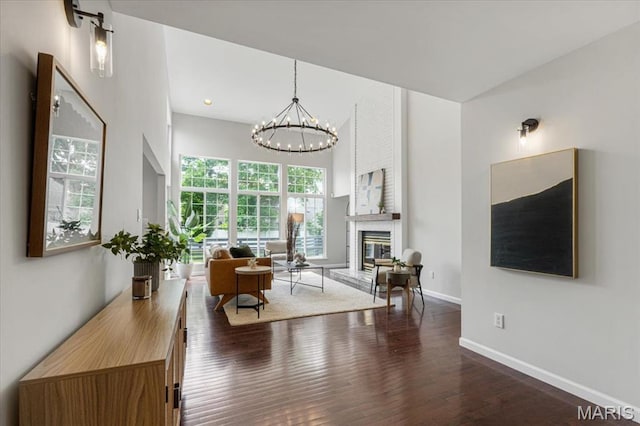 938 Blase Ave, Saint Louis, MO 63131 - living room with wood finished floors, a chandelier, and a fireplace