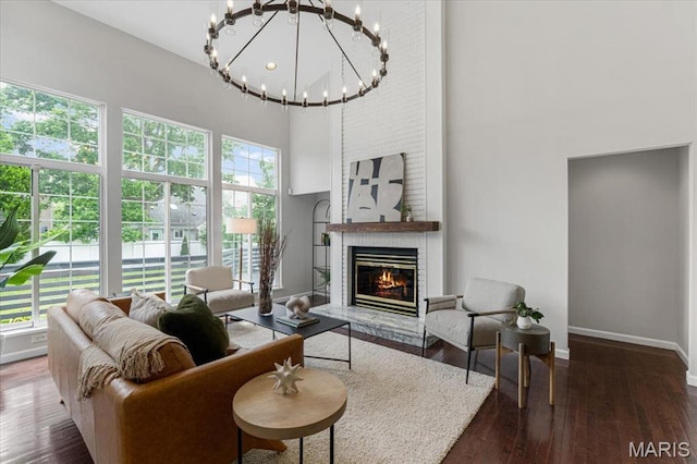 938 Blase Ave, Saint Louis, MO 63131 - living area featuring a towering ceiling, a fireplace, hardwood / wood-style flooring, and a chandelier