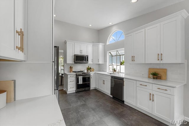 938 Blase Ave, Saint Louis, MO 63131 - kitchen featuring stainless steel appliances, white cabinetry, backsplash, and recessed lighting