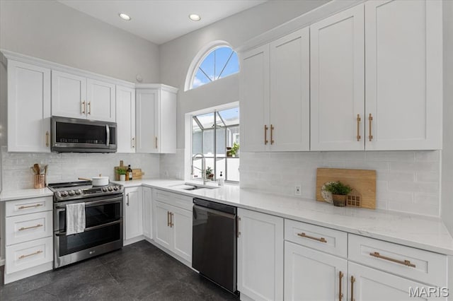 938 Blase Ave, Saint Louis, MO 63131 - kitchen with appliances with stainless steel finishes, white cabinets, light stone countertops, backsplash, and recessed lighting