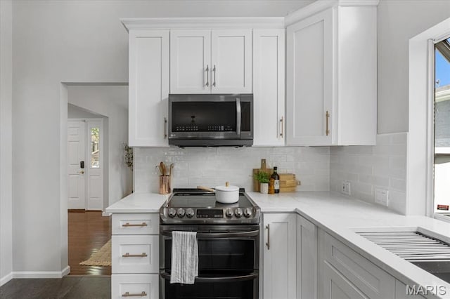 938 Blase Ave, Saint Louis, MO 63131 - kitchen with stainless steel appliances, plenty of natural light, and backsplash