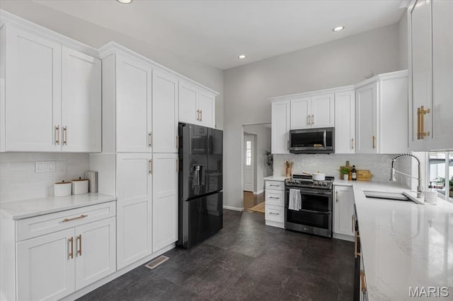 938 Blase Ave, Saint Louis, MO 63131 - kitchen featuring stainless steel appliances, white cabinetry, recessed lighting, decorative backsplash, and light stone counters
