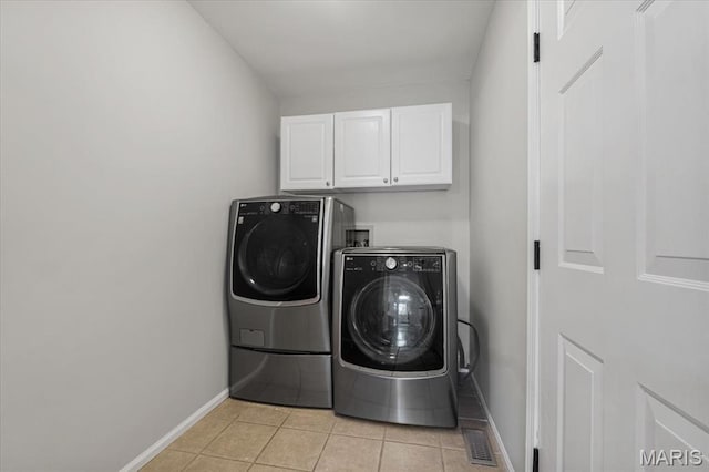 938 Blase Ave, Saint Louis, MO 63131 - laundry area featuring cabinet space, separate washer and dryer, and light tile patterned flooring