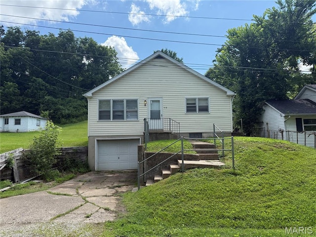 418 Monroe St, Pacific, MO 63069 - view of front of house with driveway, a front yard, and an attached garage